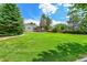 Expansive backyard with lush green grass and a charming pergola covered deck for outdoor relaxation at 2205 Santa Fe Dr, Longmont, CO 80504