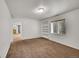 Bright basement with neutral walls, plush carpeting, built-in shelving, and a sunny window at 2205 Santa Fe Dr, Longmont, CO 80504
