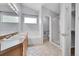Bathroom boasts a bathtub, a glass shower, dual sinks, and bright, natural light at 2205 Santa Fe Dr, Longmont, CO 80504