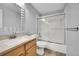 Clean bathroom featuring a large mirror, updated fixtures, and a shower-tub combo at 2205 Santa Fe Dr, Longmont, CO 80504