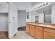 Bright bathroom featuring dual sinks, tile floors, and updated lighting fixtures at 2205 Santa Fe Dr, Longmont, CO 80504