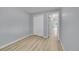 Bright bedroom featuring a ceiling fan, hardwood floors, neutral walls, and a large closet at 2205 Santa Fe Dr, Longmont, CO 80504