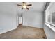 Cozy bedroom featuring neutral walls, plush carpet, and a ceiling fan for added comfort at 2205 Santa Fe Dr, Longmont, CO 80504