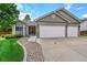 Lovely single-story home with a three-car garage, stone accents, and manicured landscaping at 2205 Santa Fe Dr, Longmont, CO 80504