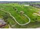 Aerial view of a meticulously maintained golf course with lush green fairways and manicured greens at 2205 Santa Fe Dr, Longmont, CO 80504