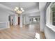 Open-concept living area with wood floors, bright neutral walls, and modern light fixtures at 2205 Santa Fe Dr, Longmont, CO 80504