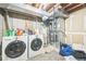 Basement laundry area with washer, dryer, and visible utility systems at 1470 S Quebec Way # 8, Denver, CO 80231