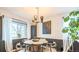 Dining room with modern light fixture, round table with black chairs, and large window at 1470 S Quebec Way # 8, Denver, CO 80231
