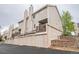Exterior view of townhome featuring garages, balconies, and neutral siding at 1470 S Quebec Way # 8, Denver, CO 80231