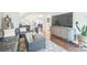 Comfortable living room with black sofa, patterned rug, television and staircase at 1470 S Quebec Way # 8, Denver, CO 80231