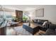 Cozy living room featuring a brick fireplace, comfortable seating, wood floors and a patterned rug at 1470 S Quebec Way # 8, Denver, CO 80231