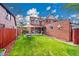Lush backyard with green lawn, wooden fence, and outdoor dining area at 3070 Colorado Blvd, Denver, CO 80207