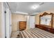 Basement bedroom with hardwood floors and a decorative wood-framed mirror at 3070 Colorado Blvd, Denver, CO 80207