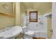 Well-lit bathroom with white tiling and a sink with silver hardware. Bathtub and toilet included at 3070 Colorado Blvd, Denver, CO 80207