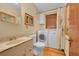 Bathroom features a washer and dryer, toilet, and sink. Natural light enhances the space at 3070 Colorado Blvd, Denver, CO 80207
