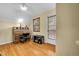 Comfortable bedroom featuring hardwood floors, a desk with drawers, and natural light at 3070 Colorado Blvd, Denver, CO 80207