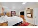 Well lit bedroom featuring an accent mirror, a flat screen TV, and a large comfy bed at 3070 Colorado Blvd, Denver, CO 80207