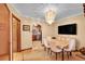Cozy dining room featuring a chandelier and an arched entrance to the kitchen at 3070 Colorado Blvd, Denver, CO 80207