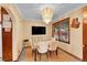 Dining room featuring modern furniture, hardwood floors, and a bright chandelier at 3070 Colorado Blvd, Denver, CO 80207