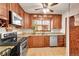 Kitchen with stainless steel appliances, wooden cabinets, hardwood floor, and granite countertops at 3070 Colorado Blvd, Denver, CO 80207