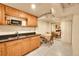 Cozy kitchen features wood cabinets, black countertop, and tile floor for a classic look at 3070 Colorado Blvd, Denver, CO 80207