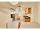 A basement kitchenette equipped with wooden cabinets and stainless steel refrigerator at 3070 Colorado Blvd, Denver, CO 80207
