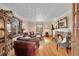 Inviting living room with hardwood floors, a stone fireplace, and comfortable leather seating at 3070 Colorado Blvd, Denver, CO 80207