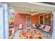 The cozy back patio has brick walls, comfortable seating, and a ceiling fan at 3070 Colorado Blvd, Denver, CO 80207
