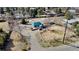 Aerial view of the property showing the blue painted house, the driveway, surrounding trees and adjacent lots at 7400 W Quincy Ave, Littleton, CO 80123