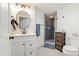 Modern bathroom with sleek white vanity, an updated shower, and contemporary fixtures, offering a clean and stylish design at 7400 W Quincy Ave, Littleton, CO 80123