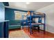 Modern bedroom features a loft bed, study area, and comfortable seating, ideal for a student at 7400 W Quincy Ave, Littleton, CO 80123