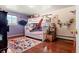 Fun bedroom featuring a bunk bed with hammock, hardwood floors, and colorful decor, perfect for or guests at 7400 W Quincy Ave, Littleton, CO 80123