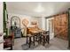 Dining room with wooden table, stools, piano, barn door, and unique decor at 7400 W Quincy Ave, Littleton, CO 80123