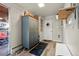 Inviting entryway featuring hardwood floors, a storage cabinet, and convenient coat hooks at 7400 W Quincy Ave, Littleton, CO 80123