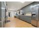 Bright kitchen featuring wood flooring, ample gray cabinets, and stainless steel refrigerator at 7400 W Quincy Ave, Littleton, CO 80123