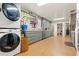 Bright kitchen features gray cabinetry, stainless steel appliances, and a stackable washer and dryer at 7400 W Quincy Ave, Littleton, CO 80123