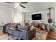 Cozy living room with a large sofa, modern furniture, hardwood floors, and plenty of natural light from the window at 7400 W Quincy Ave, Littleton, CO 80123