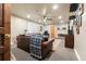 Cozy living room with a leather sofa, fireplace, ceiling fan, and neutral carpet at 7400 W Quincy Ave, Littleton, CO 80123
