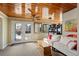 Bright sunroom with wood ceiling, striped sofa, French doors, and outdoor views at 7400 W Quincy Ave, Littleton, CO 80123