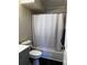 Cozy bathroom with dark floors, gray vanity, and a shower with a white curtain at 2160 S Vaughn Way # 204C, Aurora, CO 80014