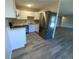 Bright kitchen featuring white cabinets, stainless steel appliances, light countertops and wood-look floors at 2160 S Vaughn Way # 204C, Aurora, CO 80014