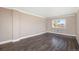 Bright bedroom featuring dark floors, neutral walls, and a large window at 7040 E Girard Ave # 104, Denver, CO 80224