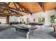 Well-appointed game room featuring two pool tables, high ceilings, and an adjacent seating area at 7040 E Girard Ave # 104, Denver, CO 80224
