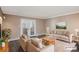Cozy living room with neutral furniture, doors to patio, and hardwood floors at 7040 E Girard Ave # 104, Denver, CO 80224