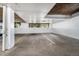 Underground parking garage featuring parking spots with unit numbers and visible support pillars at 7040 E Girard Ave # 104, Denver, CO 80224