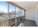 Bright sun room with large windows offering views, and a neutral-toned floor at 7040 E Girard Ave # 104, Denver, CO 80224