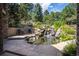 Backyard pond with waterfall and serene stone patio at 5170 Pinyon Jay Rd, Parker, CO 80134