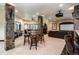 Basement with stone pillars, fireplace, pool table, wet bar, and large seating area at 5170 Pinyon Jay Rd, Parker, CO 80134