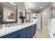 Bathroom featuring double sinks, ornate mirrors, and tile floors at 5170 Pinyon Jay Rd, Parker, CO 80134