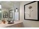 Stylish powder room with travertine countertop and custom lighting at 5170 Pinyon Jay Rd, Parker, CO 80134